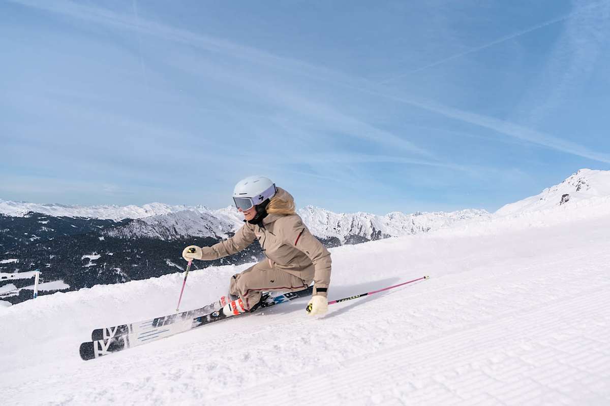 Frau beim Skifahren in Südtirol auf perfekter Piste mit Panoramablick.