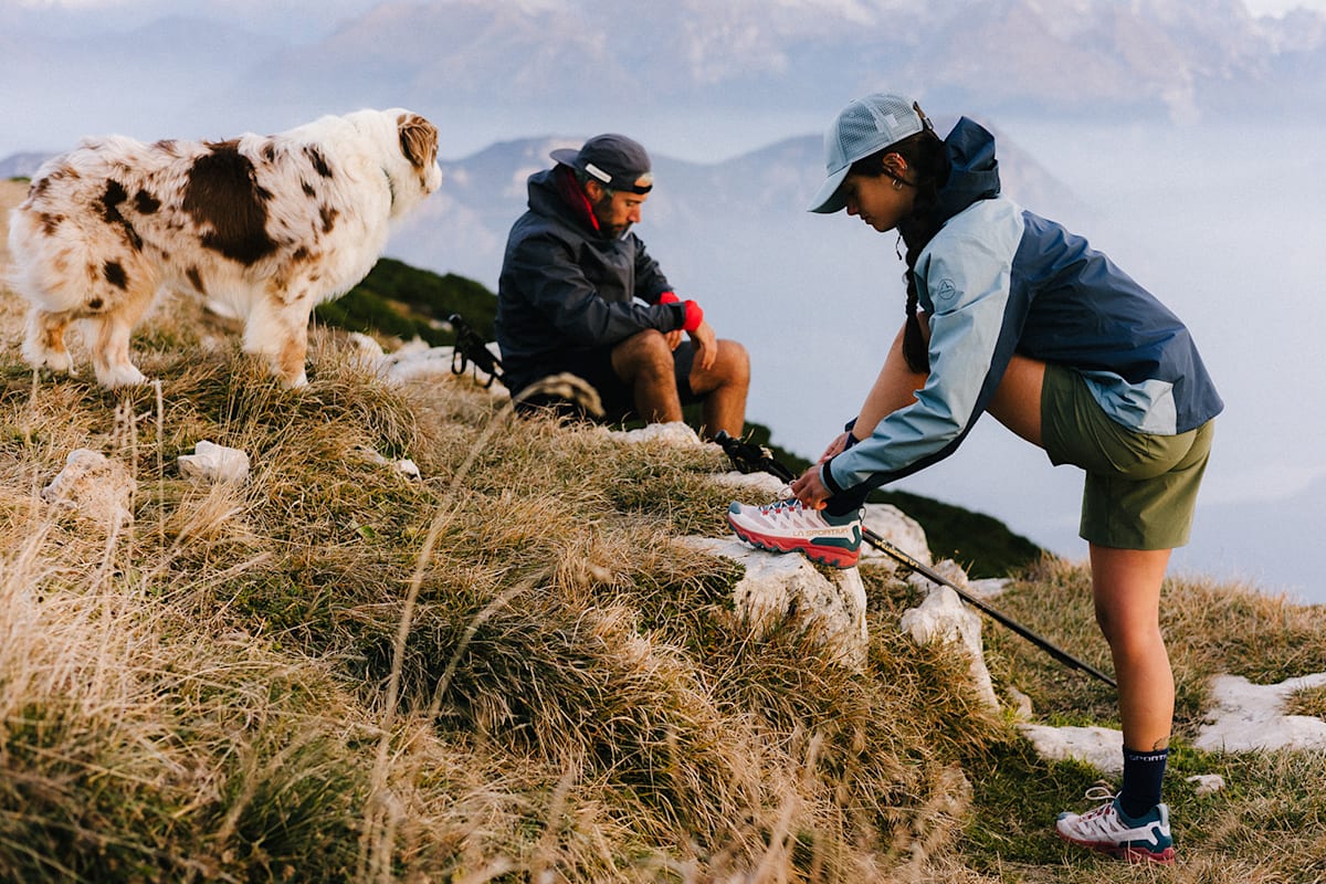 Eine Frau macht sich die Schuhe von La Sportiva zu.