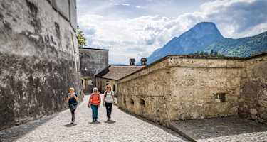 Wanderer entdecken die Festung Kufstein mit Blick auf die Alpen