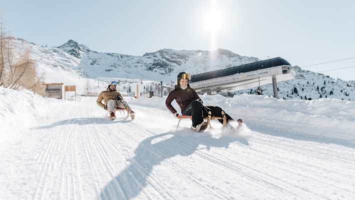 Mit rasanter Fahrt durch die glitzernde Winterlandschaft wird das Rodeln zum unvergesslichen Spaß für Groß und Klein.