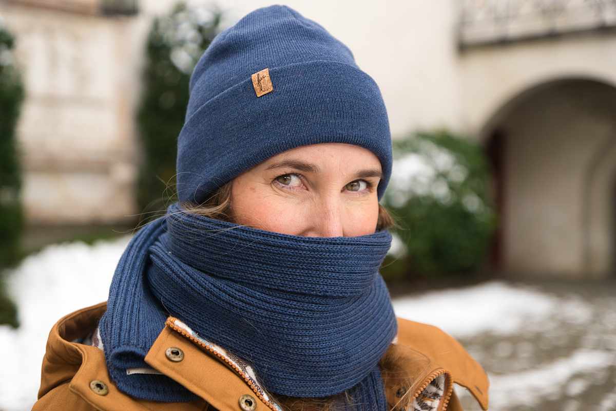 Portrait einer Frau, die mit Schal und Mütze bekleidet ist