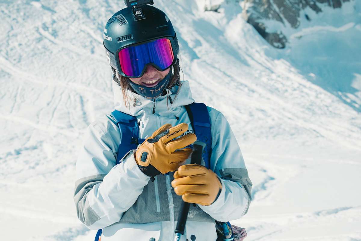 Freeriderin mit Therm-ic Freeride Ultra Heat Lederhandschuhen beim Skifahren in verschneiter Berglandschaft – beheizbare Handschuhe für extreme Wetterbedingungen.