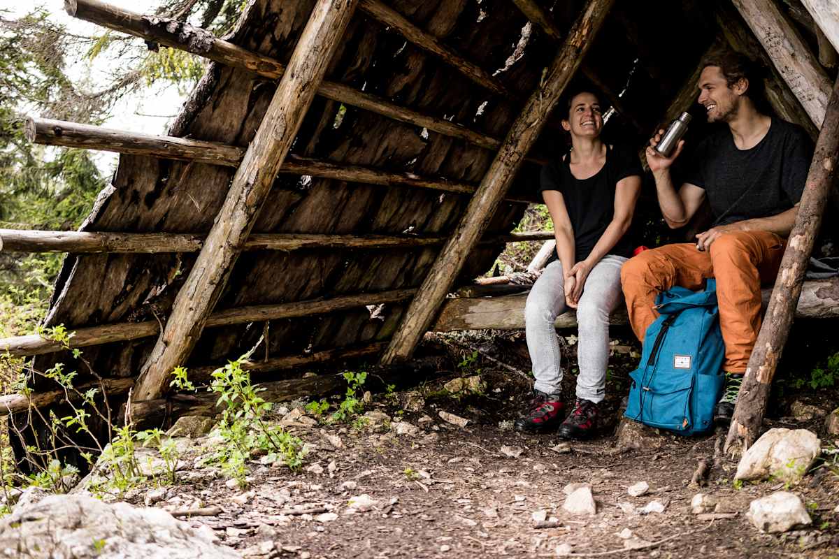 Zwei Wanderer machen Rast in einem Unterschlupf.