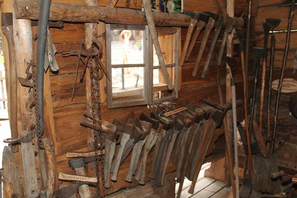 Alte Äxte hängen an einer Wand im Holzmuseum.
