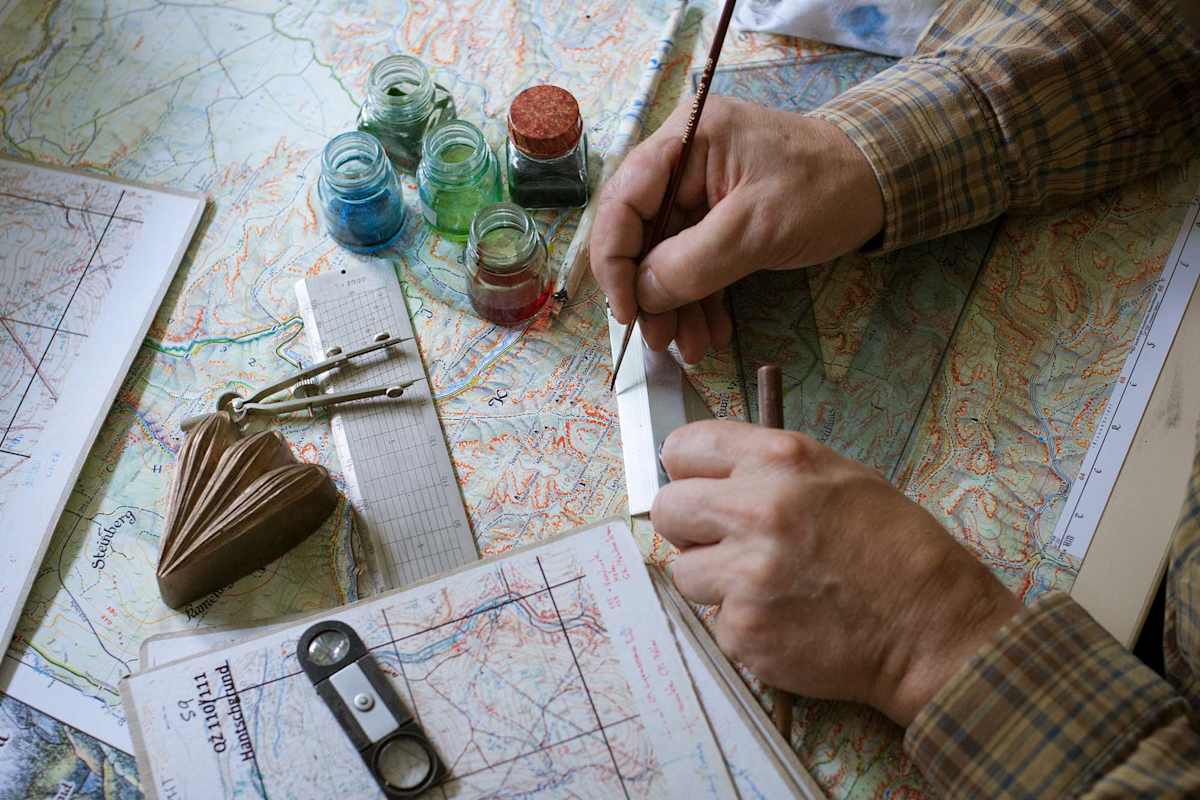 Rolf beim Zeichnen der Karten.