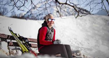Eine Bank in der Sonne lädt zur Rast auf der Langlauftour bei Oberstdorf ein.