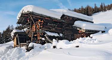 Hundertjähriges Holz eingebettet in das vergängliche Weiß der Winterlandschaft.