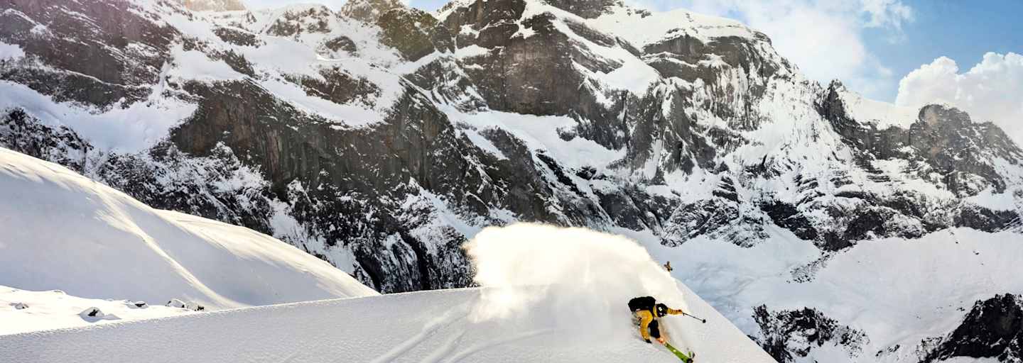 Ein Freerider fährt über das Dach einer Hütte.