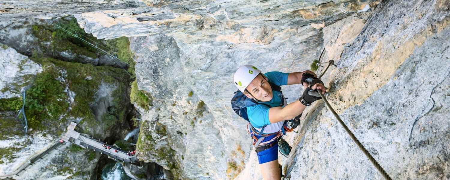 Ein Kletterer in einer steilen Bergwand.