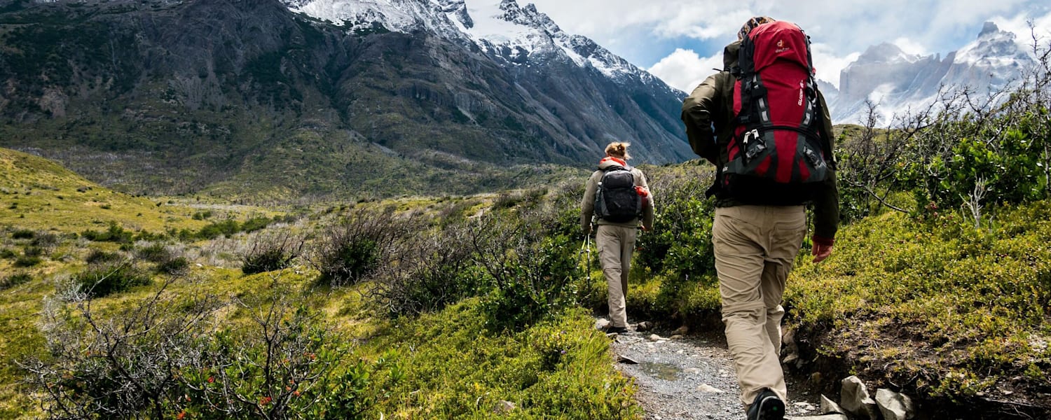 Zwei Personen gehen in der Natur wandern.