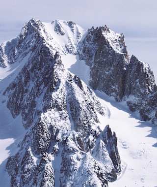 Ein Winterbild: Gut zu sehen die steile Firnflanke  und der Glacier du Milieu, über den der Abstieg, aber auch der leichteste Aufstieg auf den Gipfel geht.