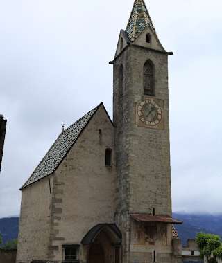 Altenburg Kirche. Dort zweigt der Weg zur Ruine St. Peter ab, der über eine Aussichtskanzel mit herrlichem Tiefblick zum Kalterer See, eine felsige Stufe und eine spektakuläre Hängebrücke zum St.-Peters-Bühel führt.