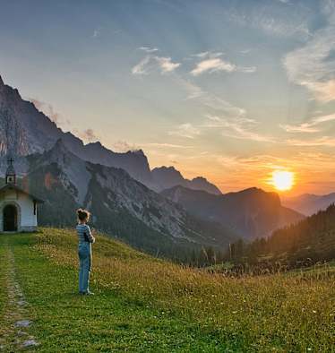 Mädchen bei Sonnenuntergang am Berg