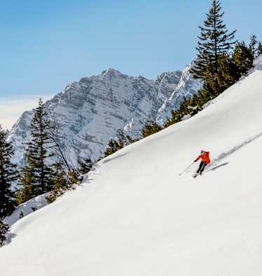 Schifahrer zieht die ersten Spuren im Neuschnee