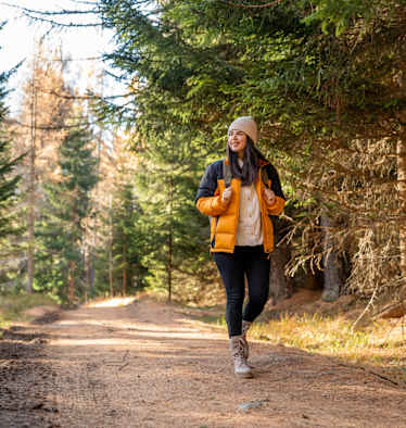 Frau wandert im wald im herbst