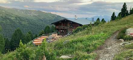 Das Almgasthaus Boscheben schmiegt sich an den Hang.