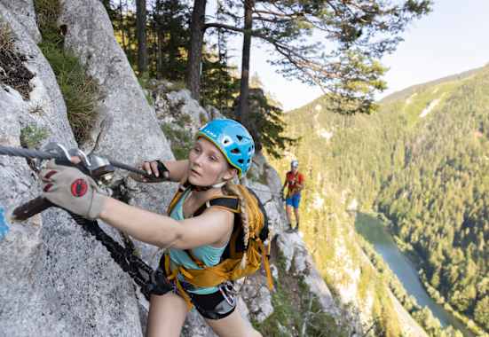 Junge Frau am Klettersteig