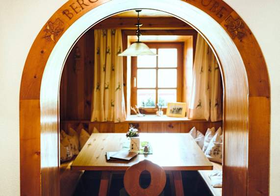 Stube mit Torbogen aus Holz.