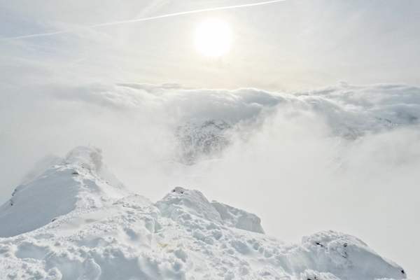 Wolken werden über die umliegende Bergwelt gedrückt