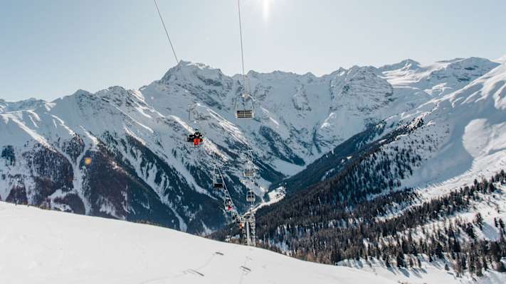 Skifahrer sitzen in einer Liftanlage in Trafoi.