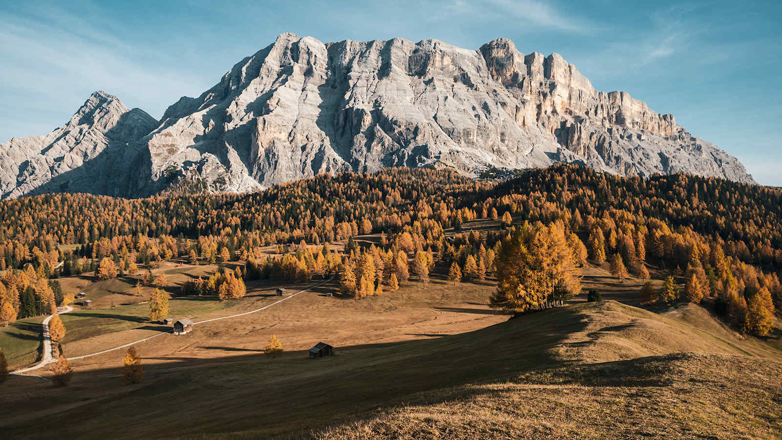 Die Dolomiten umgeben von herbstlichen Wäldern.