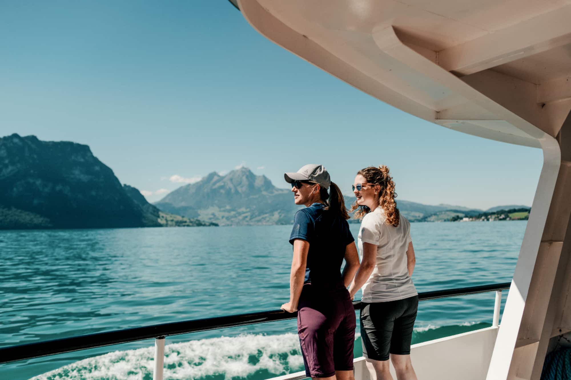 Tell-Trail Etappe 3 - Zwei Wanderinnen auf dem Schiff nach Luzern auf dem Vierwaldstättersee mit dem Pilatus und der Hammetschwand im Hintergrund