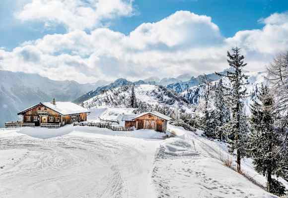 Die Hochwurzenhütte eingebettet in ein winterliches Panorama
